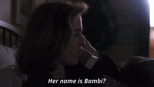a woman laying on a bed with the words her name is bambi behind her