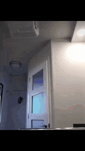 a bathroom with a door that has a window on it
