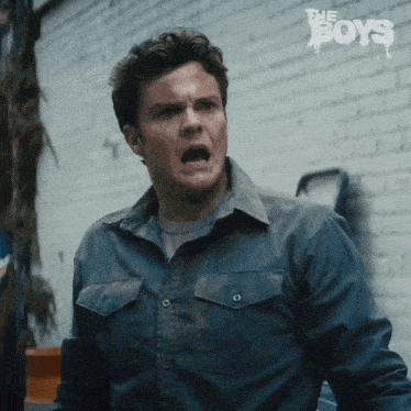 a man in a blue shirt with the word boys on the bottom