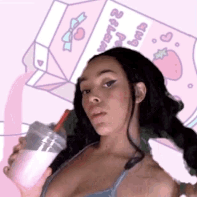 a woman is holding a cup of milk with a straw in front of a milk carton .