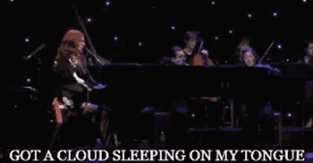 a woman singing into a microphone with the words " got a cloud sleeping on my tongue " next to her