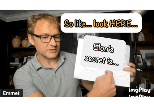 a man holding a piece of paper that says " elon 's secret is "