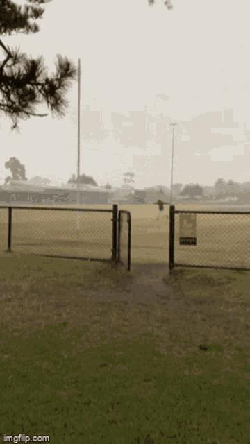 a field with a fence and a sign that says soccer