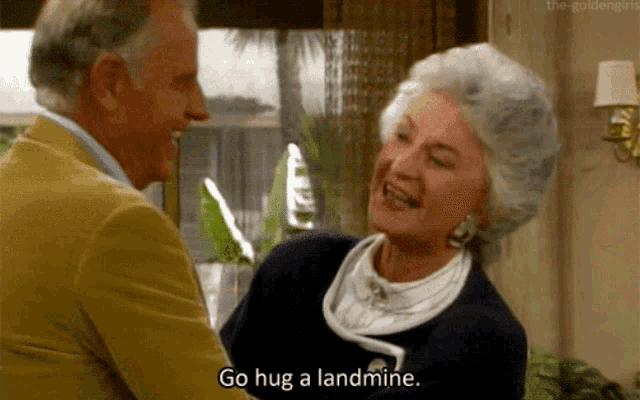 an elderly woman says go hug a landmine while hugging a man
