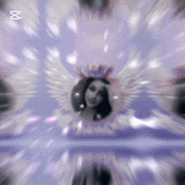 a blurry picture of a woman wearing a crown and wings