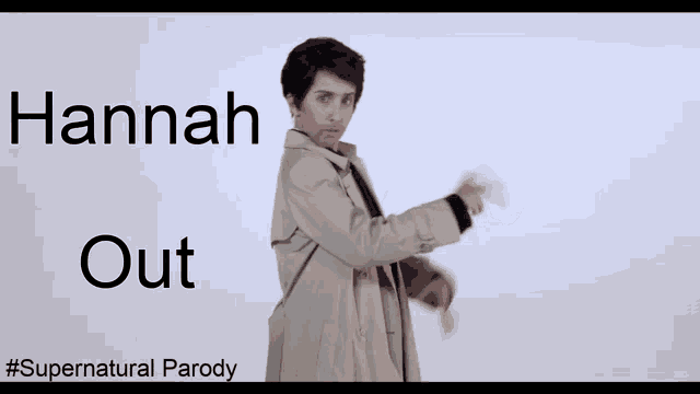 a man in a trench coat is standing in front of a white wall with hannah out written on it
