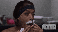 a woman is shaving her face with the name juwanna mann on the bottom right