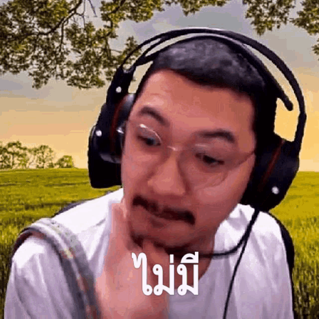 a man with a mustache and glasses is wearing headphones .