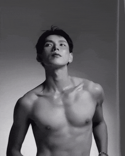 a man without a shirt is looking up at the camera
