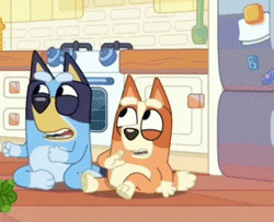two cartoon dogs are sitting next to each other on the floor in a kitchen .