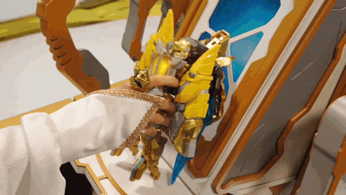 a person is playing with a toy robot with a sword and shield