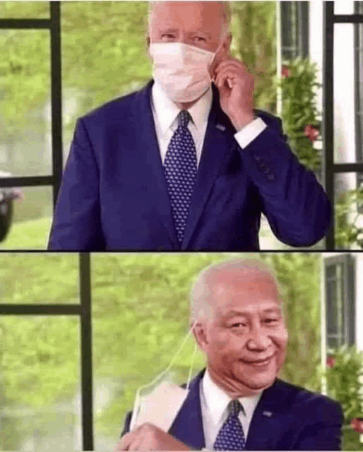a man in a suit and tie is wearing a mask .