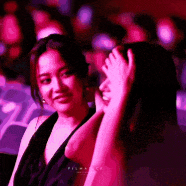two women are sitting in a dark room and the word filmance is on the bottom left
