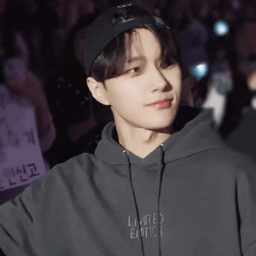a young man wearing a limited edition hoodie and hat