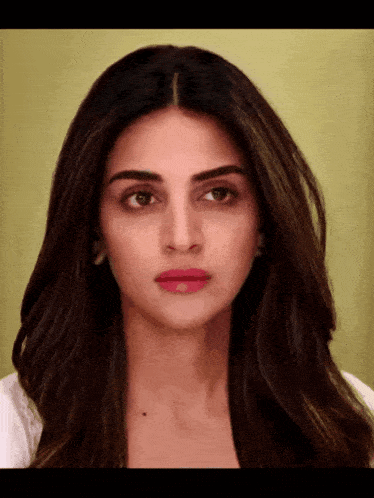a close up of a woman 's face with long dark hair