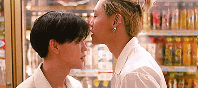 a couple of young men are kissing in a store .