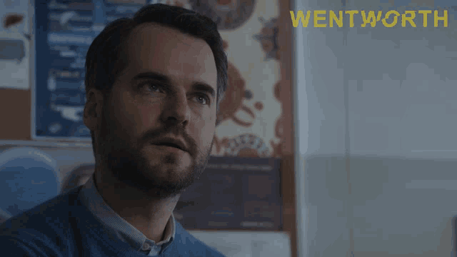 a man says sit down in front of a wentworth poster