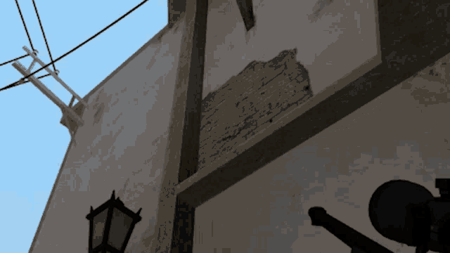 a sniper scope is mounted on a pole outside of a building