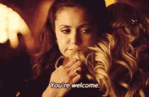 a woman is hugging another woman and saying you 're welcome