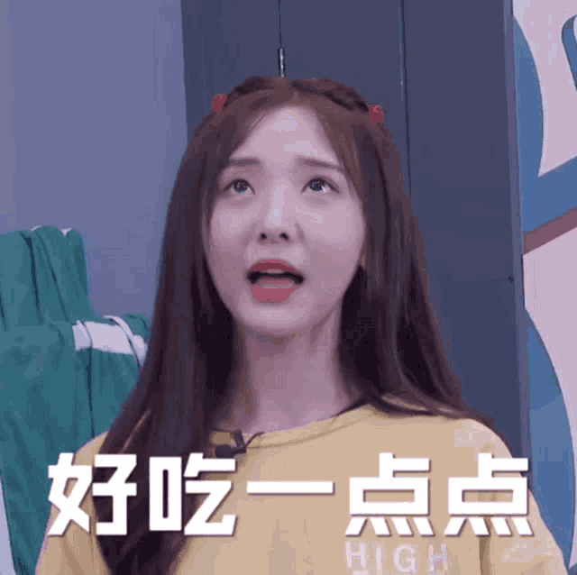 a girl wearing a yellow shirt has chinese writing on her face