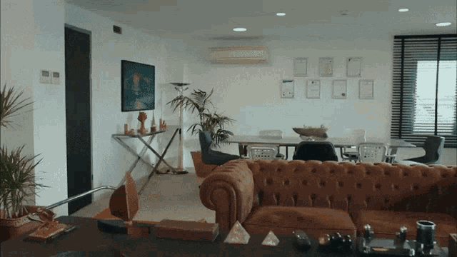 a living room with a brown couch and a pyramid