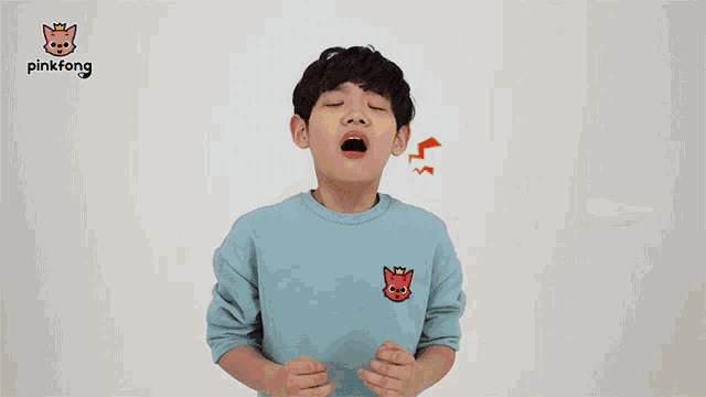 a pinkfong advertisement with a boy and a shark mascot