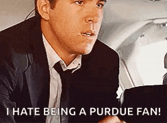 a man in a suit and tie is saying that he hates being a purdue fan .