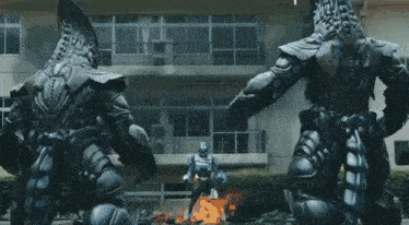 a person in a superhero costume is holding a sword and shield .
