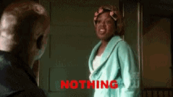 a woman in a bathrobe is standing next to a man with the word nothing in red letters