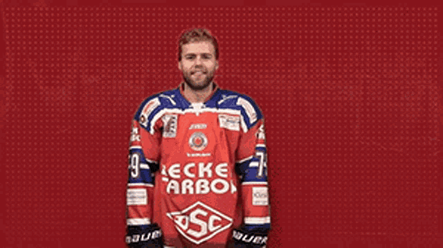 a hockey player wearing a red and blue jersey that says beckel carbon