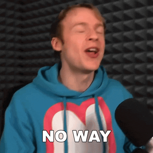 a man in a blue hoodie is singing into a microphone while wearing a no way shirt .