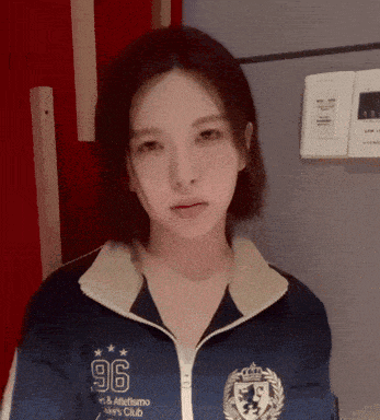 a woman wearing a blue jacket that says 96 on it