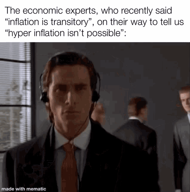 a man in a suit and tie is wearing headphones .