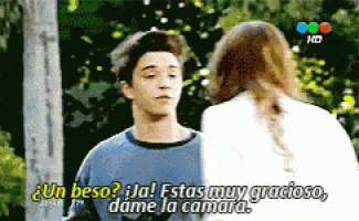 a man and a woman are talking in spanish and the woman is saying un beso