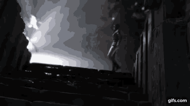 a man is standing on top of a set of stairs .