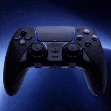 a black video game controller is floating in the air with a blue background