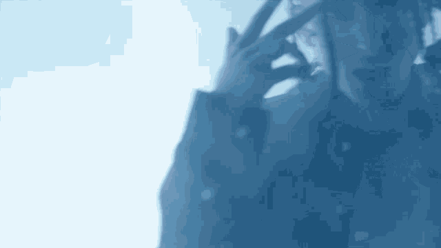a person is talking on a cell phone behind a glass