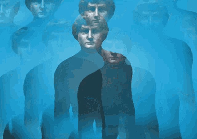 a group of people are standing in a line with their faces obscured