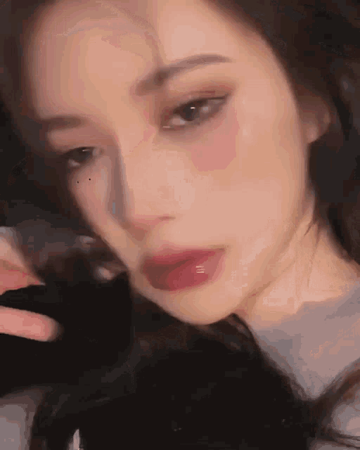 a close up of a woman 's face with red lipstick on her lips