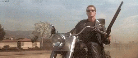 Arnold Schwarzenegge Motorcycle GIF - Arnold Schwarzenegge Motorcycle Gun GIFs