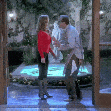 a man and a woman are standing in front of a pool