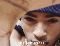 a close up of a person 's face with the words jahs selfies on the bottom .