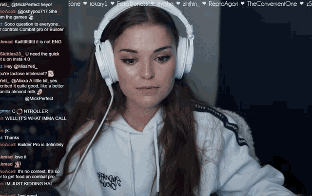 a woman wearing headphones is looking at a screen with a lot of comments on it
