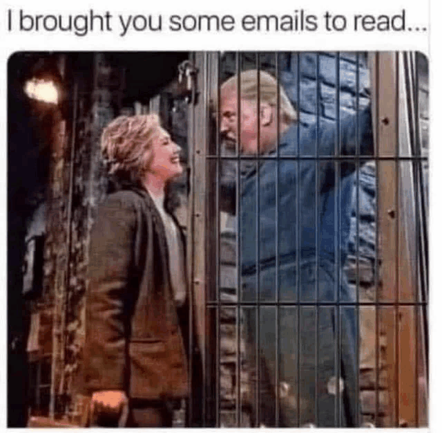 a man and a woman are standing next to each other behind bars .