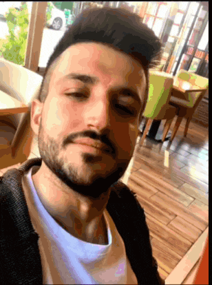 a man with a beard is taking a picture of himself in a restaurant