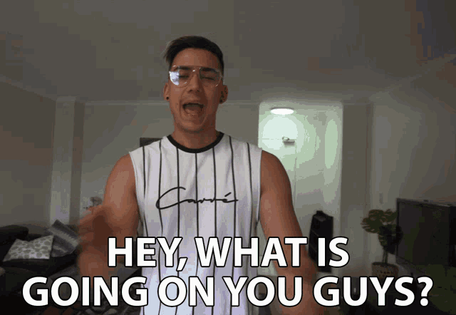 a man wearing glasses and a striped tank top says hey what is going on you guys