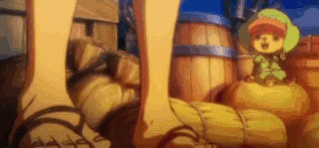 a close up of a person 's feet and a cartoon character sitting on a pile of barrels .