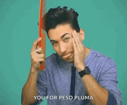 a man is brushing his hair with a comb and says `` you for peso pluma '' while pointing at the camera .