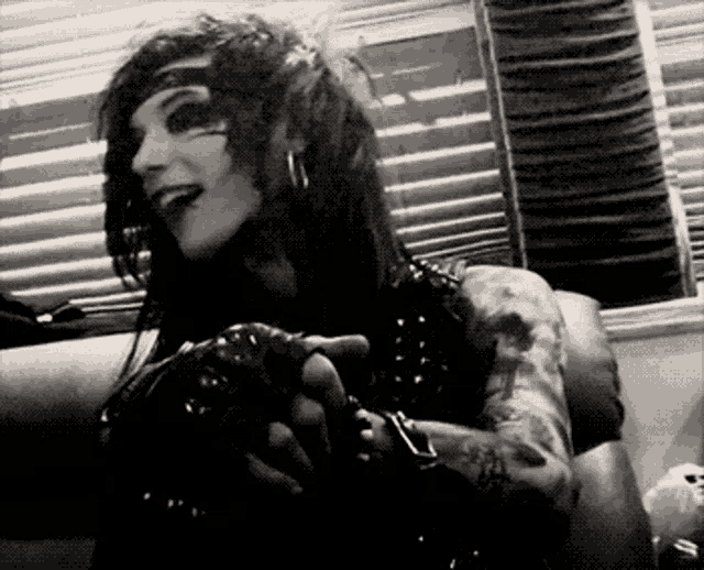 a black and white photo of a man with tattoos