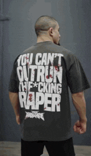 a man is wearing a shirt that says you can 't outrun the fucking rapper